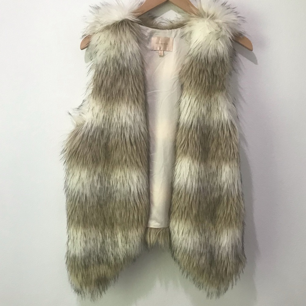 cream and white animal fur vest